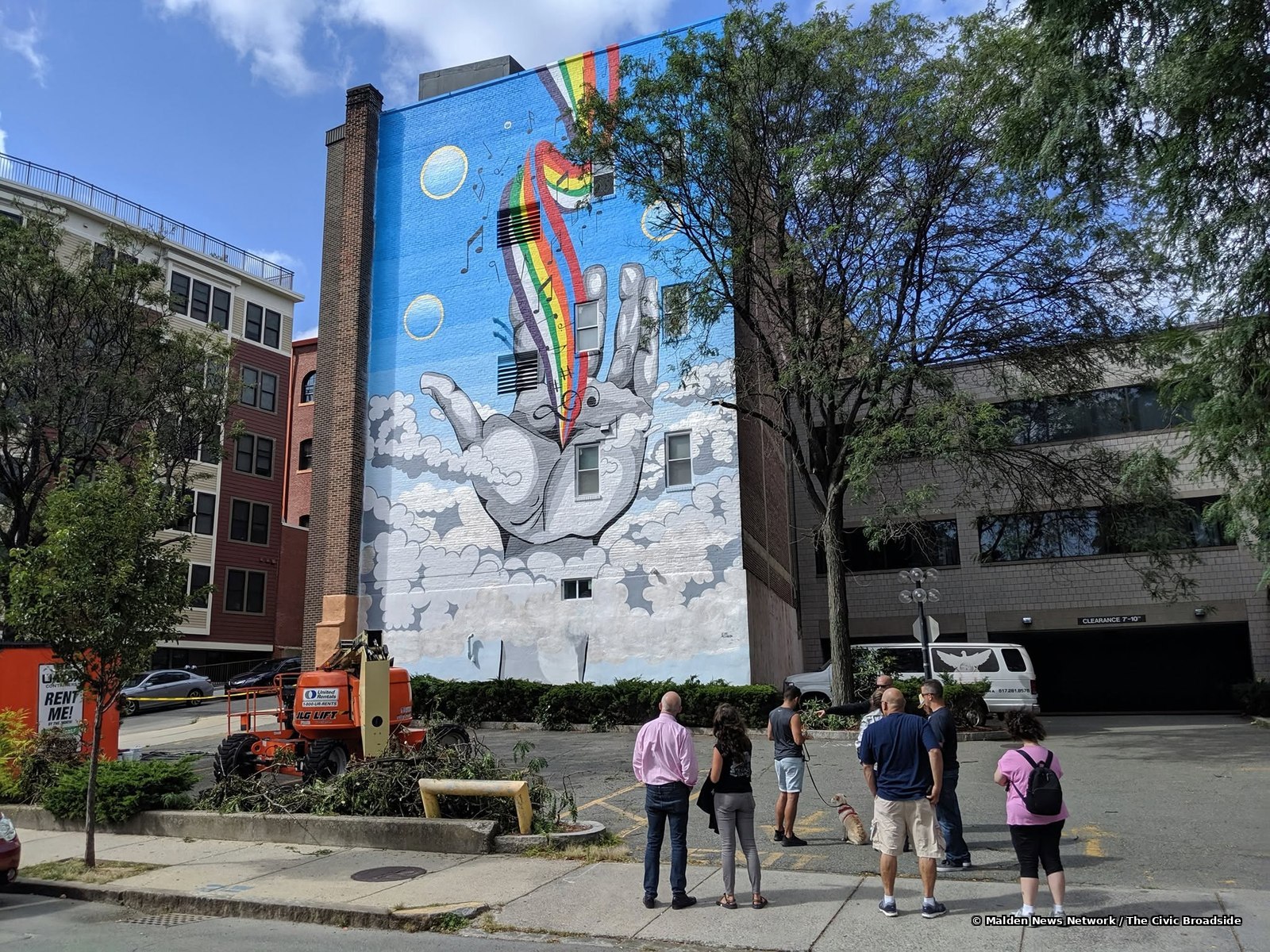 Early admirers viewing the finished mural