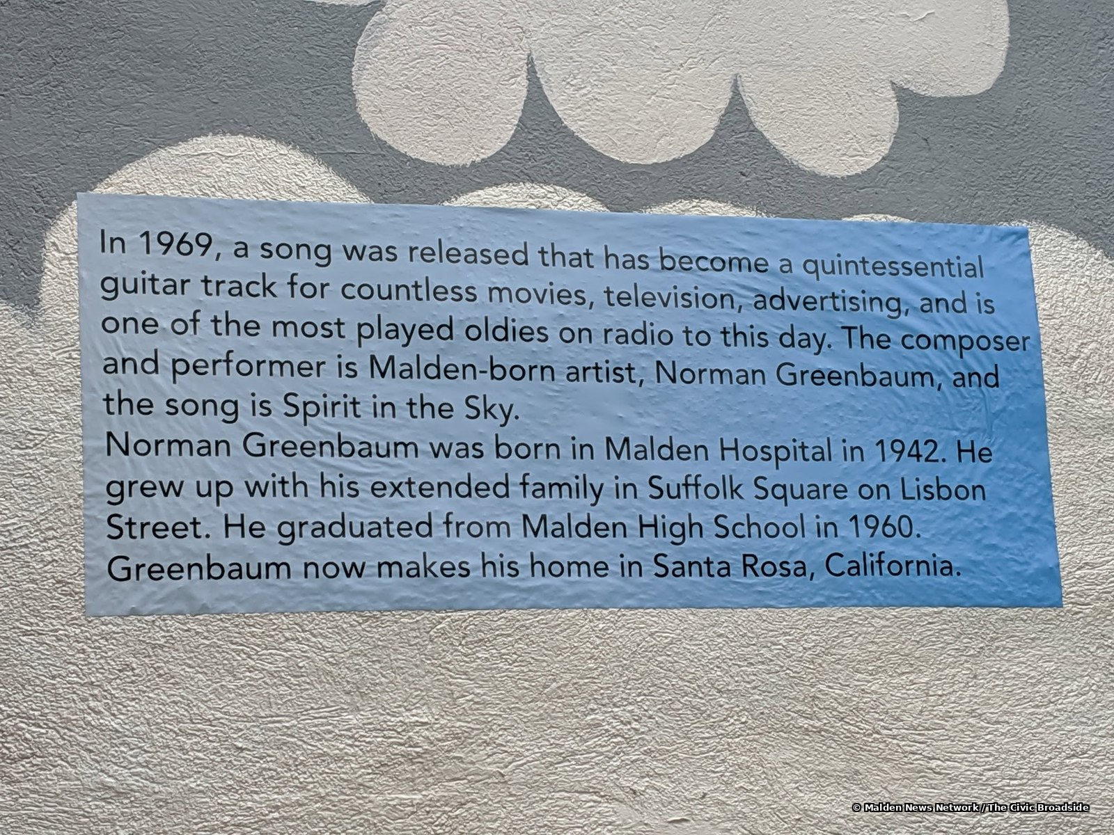 A biographical sketch of Greenbaum displayed at the mural