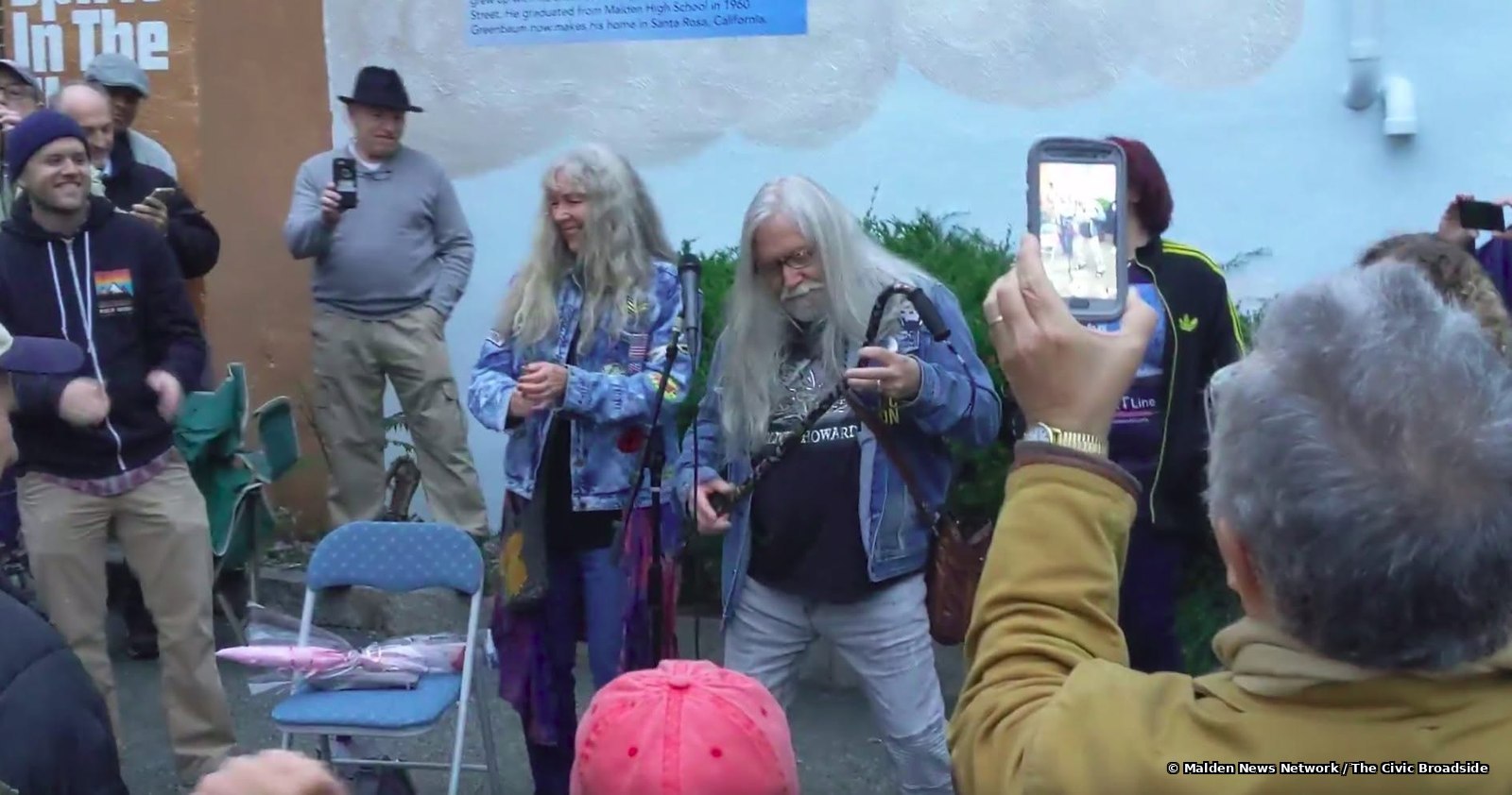 Norman Greenbaum playing air guitar to huge applause